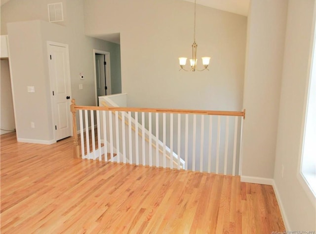 148 Gallup Hill Rd, Ledyard, CT 06339 - unfurnished room with wood finished floors, a chandelier, baseboards, and high vaulted ceiling