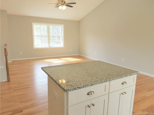148 Gallup Hill Rd, Ledyard, CT 06339 - kitchen with a ceiling fan, light wood finished floors, a kitchen island, light stone countertops, and lofted ceiling