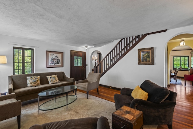 128 Blake Rd, Hamden, CT 06517 - living room with arched walkways, wood finished floors, a textured ceiling, and stairway