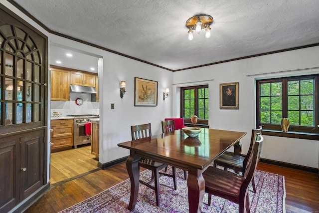 128 Blake Rd, Hamden, CT 06517 - dining room featuring hardwood / wood-style floors, a textured ceiling, crown molding, and baseboards