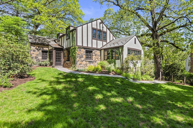 128 Blake Rd, Hamden, CT 06517 - back of property featuring stone siding, a yard, and board and batten siding