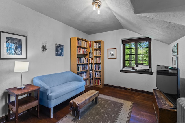 128 Blake Rd, Hamden, CT 06517 - living area with wood finished floors, a textured ceiling, baseboards, and lofted ceiling