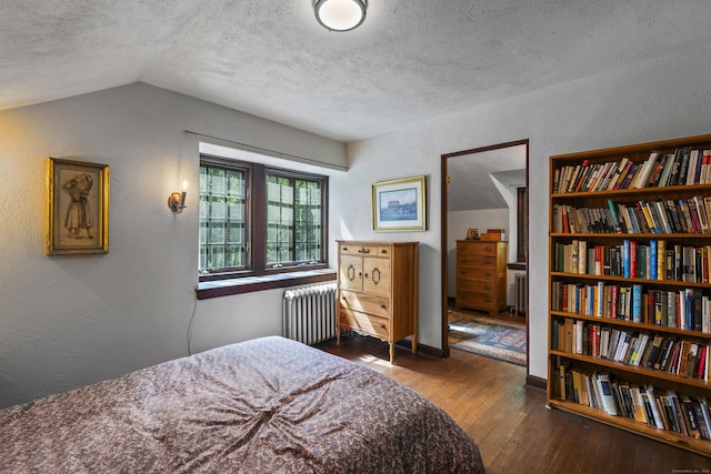 128 Blake Rd, Hamden, CT 06517 - bedroom with radiator heating unit, wood finished floors, a textured wall, a textured ceiling, and vaulted ceiling