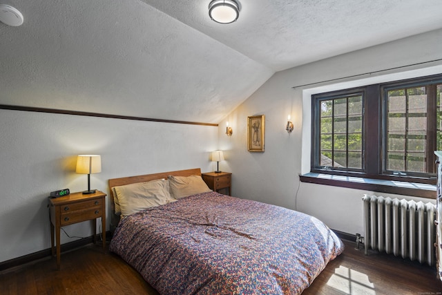 128 Blake Rd, Hamden, CT 06517 - bedroom with radiator heating unit, lofted ceiling, wood finished floors, a textured ceiling, and baseboards