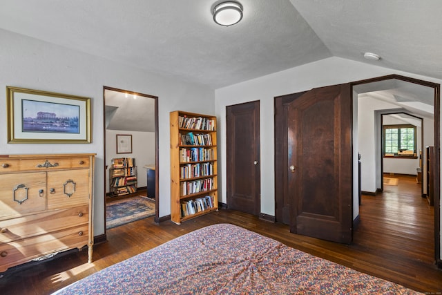 128 Blake Rd, Hamden, CT 06517 - bedroom with dark wood-type flooring, lofted ceiling, baseboards, and a textured ceiling