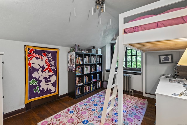 128 Blake Rd, Hamden, CT 06517 - bedroom with radiator heating unit, wood finished floors, vaulted ceiling, and baseboards