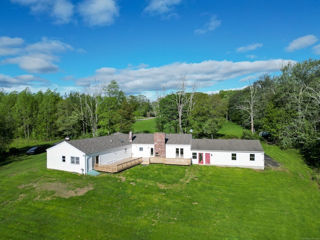 125 Woodchuck Ln, Harwinton, CT 06791 - rear view of house featuring a wooden deck, a yard, a wooded view, and a chimney