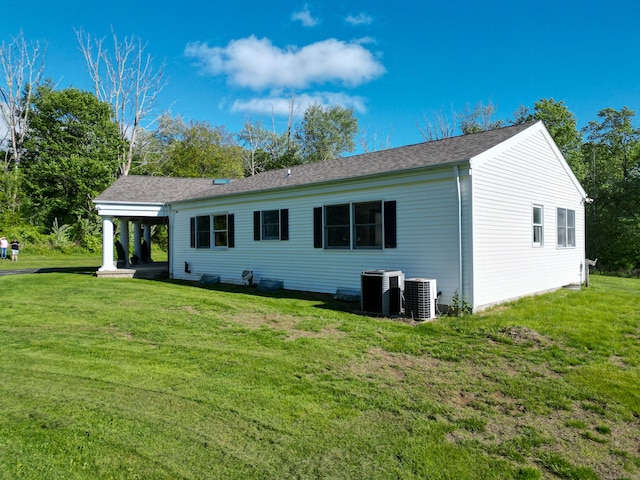 125 Woodchuck Ln, Harwinton, CT 06791 - rear view of property featuring central air condition unit, a yard, and a shingled roof