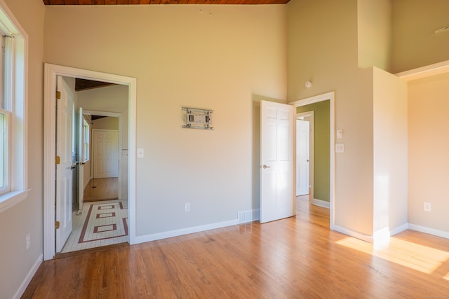 125 Woodchuck Ln, Harwinton, CT 06791 - unfurnished bedroom featuring light wood-type flooring, high vaulted ceiling, and baseboards