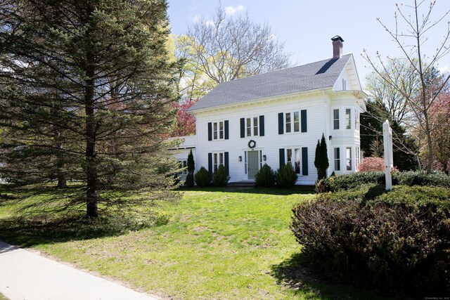 308 Main St, Salisbury, CT 06039 - view of front of house with a chimney, a front yard, and a shingled roof
