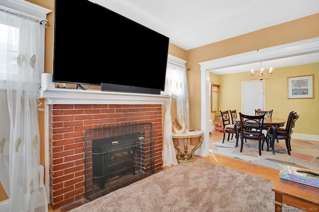 809 Burnside Ave, East Hartford, CT 06108 - living area featuring a fireplace, a chandelier, wood finished floors, and baseboards