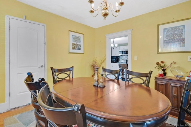 809 Burnside Ave, East Hartford, CT 06108 - dining area with a chandelier and wood finished floors
