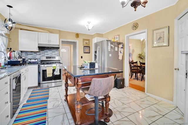 809 Burnside Ave, East Hartford, CT 06108 - kitchen with appliances with stainless steel finishes, under cabinet range hood, light marble finish floors, tasteful backsplash, and white cabinetry