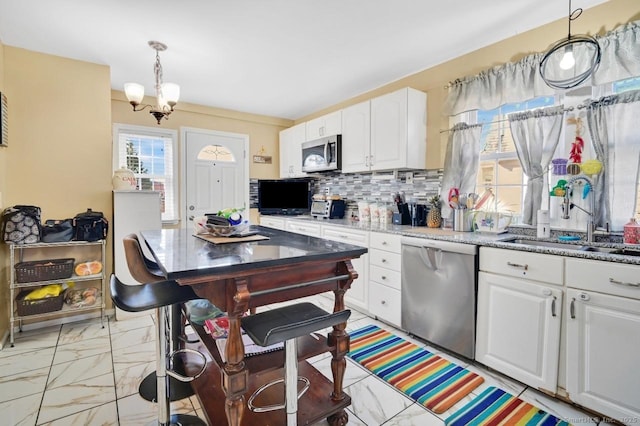 809 Burnside Ave, East Hartford, CT 06108 - kitchen with stainless steel appliances, a sink, light marble finish floors, and white cabinets