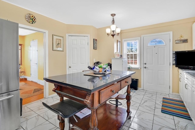 809 Burnside Ave, East Hartford, CT 06108 - dining room with light marble finish flooring and a chandelier