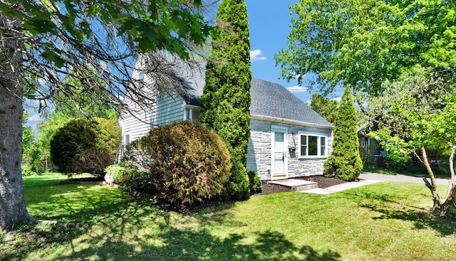 43 Ronald Rd, New Britain, CT 06053 - view of front facade featuring a front lawn, stone siding, and a shingled roof