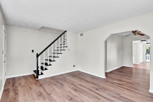 43 Ronald Rd, New Britain, CT 06053 - unfurnished living room with ceiling fan, wood finished floors, stairs, arched walkways, and baseboards