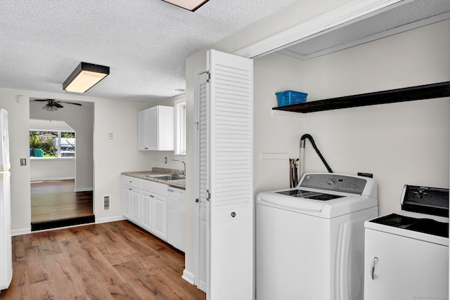 43 Ronald Rd, New Britain, CT 06053 - laundry area featuring light wood-style floors, ceiling fan, a textured ceiling, washing machine and clothes dryer, and baseboards