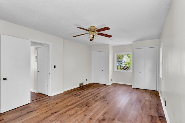 43 Ronald Rd, New Britain, CT 06053 - unfurnished bedroom with multiple closets, wood finished floors, baseboards, and ceiling fan