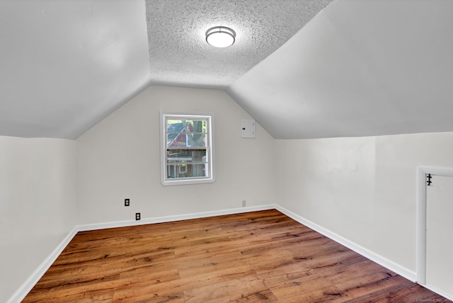 43 Ronald Rd, New Britain, CT 06053 - additional living space with wood finished floors, vaulted ceiling, baseboards, and a textured ceiling