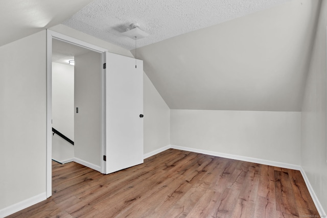 43 Ronald Rd, New Britain, CT 06053 - additional living space featuring wood finished floors, vaulted ceiling, baseboards, and a textured ceiling