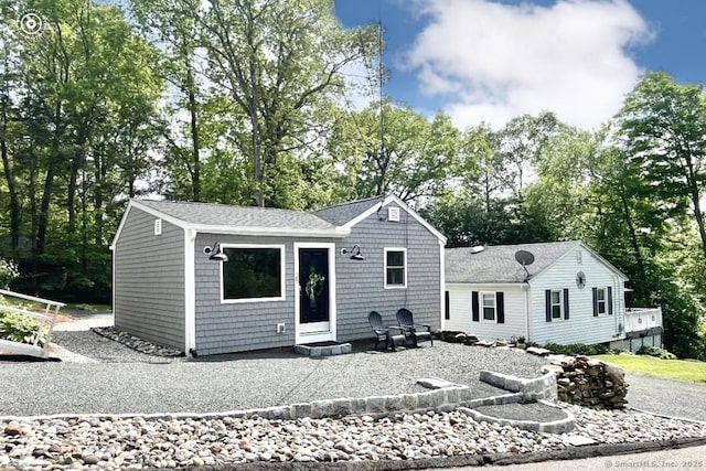 25 Mohawk Trl, East Hampton, CT 06424 - rear view of property with a shingled roof and view of wooded area