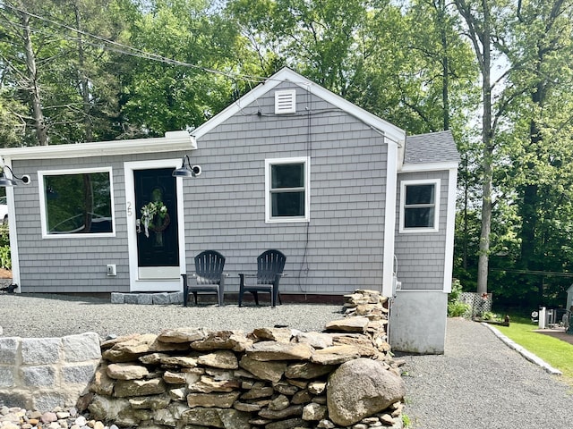 25 Mohawk Trl, East Hampton, CT 06424 - back of house featuring a shingled roof and view of scattered trees