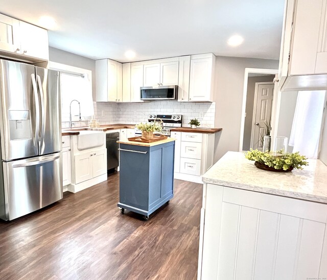 25 Mohawk Trl, East Hampton, CT 06424 - kitchen featuring stainless steel appliances, wooden counters, white cabinetry, dark wood-type flooring, and backsplash