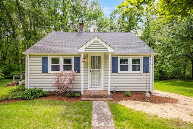 33 Hurlbut Rd, Tolland, CT 06084 - bungalow-style house featuring roof with shingles, a front lawn, and a chimney