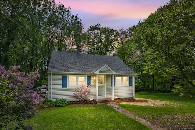 33 Hurlbut Rd, Tolland, CT 06084 - view of front facade with roof with shingles, a front lawn, and a chimney