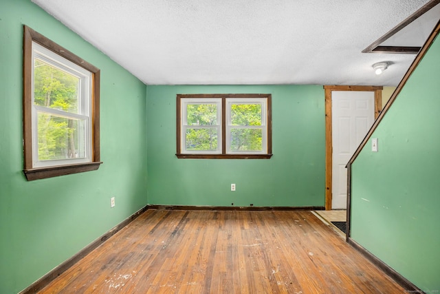 33 Hurlbut Rd, Tolland, CT 06084 - unfurnished room with hardwood / wood-style flooring, a textured ceiling, and baseboards