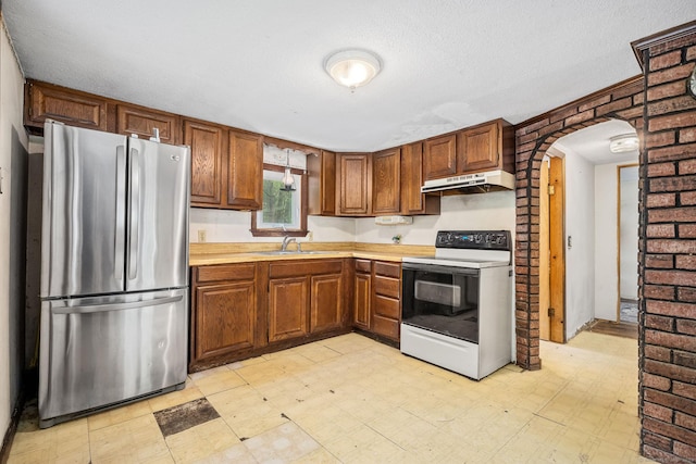 33 Hurlbut Rd, Tolland, CT 06084 - kitchen with freestanding refrigerator, white electric range oven, under cabinet range hood, and light flooring