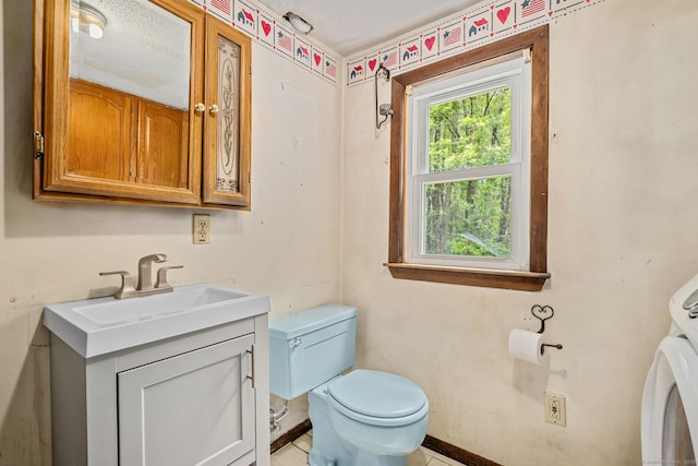 33 Hurlbut Rd, Tolland, CT 06084 - half bath with toilet, vanity, tile patterned flooring, washer / dryer, and baseboards