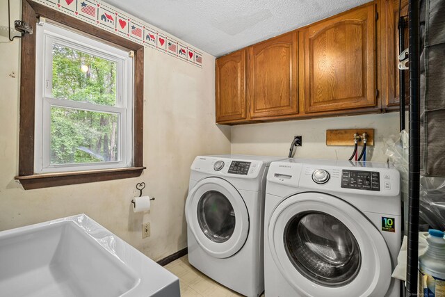 33 Hurlbut Rd, Tolland, CT 06084 - laundry room with cabinet space, separate washer and dryer, baseboards, and a textured ceiling