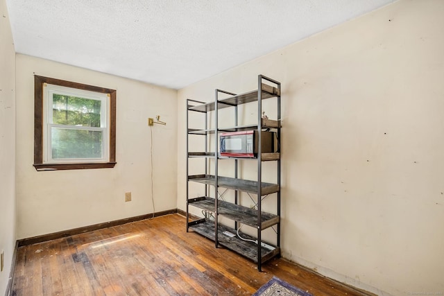 33 Hurlbut Rd, Tolland, CT 06084 - empty room with hardwood / wood-style floors, baseboards, and a textured ceiling