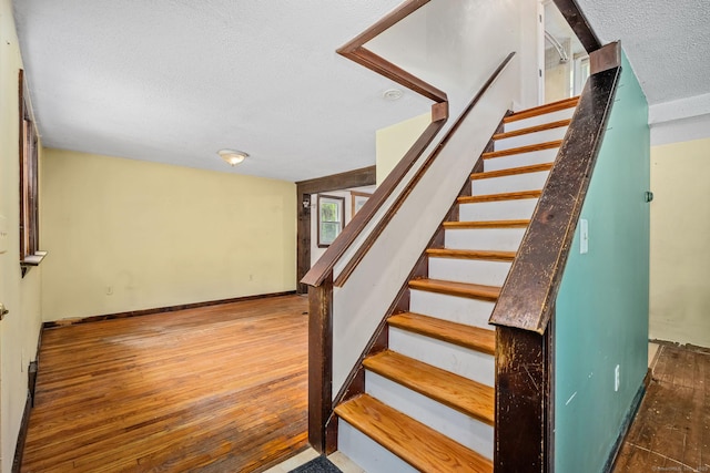 33 Hurlbut Rd, Tolland, CT 06084 - stairs with a textured ceiling, wood finished floors, and baseboards