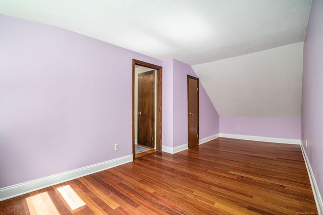 33 Hurlbut Rd, Tolland, CT 06084 - additional living space featuring wood finished floors, baseboards, and vaulted ceiling