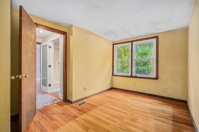 33 Hurlbut Rd, Tolland, CT 06084 - spare room featuring light wood-style floors, baseboards, and a textured ceiling