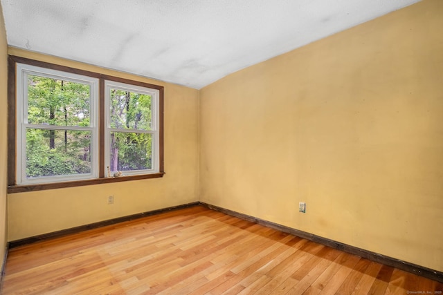 33 Hurlbut Rd, Tolland, CT 06084 - spare room with light wood finished floors, baseboards, and vaulted ceiling