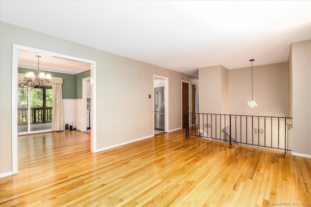 31 Buckingham Rd, New Milford, CT 06776 - unfurnished room with a chandelier, wood finished floors, and baseboards