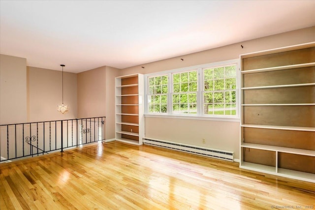 31 Buckingham Rd, New Milford, CT 06776 - spare room with a baseboard heating unit and wood finished floors