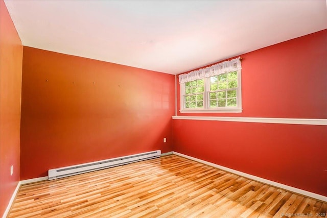 31 Buckingham Rd, New Milford, CT 06776 - empty room featuring a baseboard heating unit, wood finished floors, and baseboards
