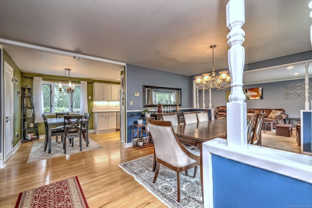 54 Mariot Cir, Wallingford, CT 06492 - dining area featuring a chandelier, light wood-style flooring, and baseboards