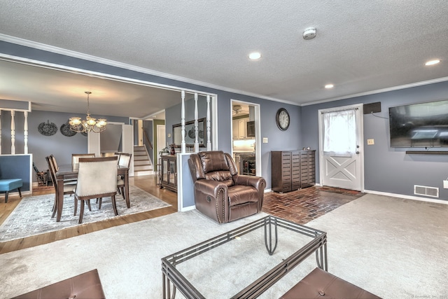 54 Mariot Cir, Wallingford, CT 06492 - carpeted living area with crown molding, a chandelier, baseboards, stairway, and a textured ceiling