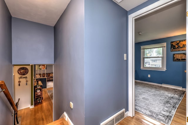 54 Mariot Cir, Wallingford, CT 06492 - hall featuring a baseboard radiator, an upstairs landing, wood finished floors, and baseboards