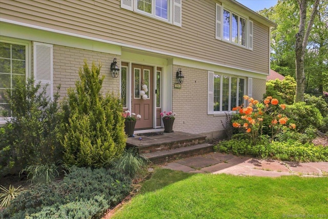 190 Bronson Dr, Middlebury, CT 06762 - doorway to property with brick siding and a lawn