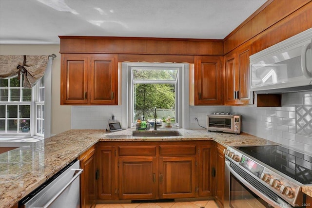 190 Bronson Dr, Middlebury, CT 06762 - kitchen featuring stainless steel appliances, a sink, backsplash, and light stone countertops