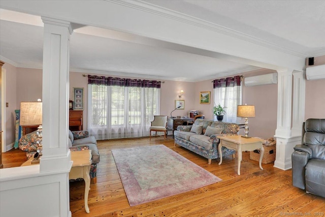 190 Bronson Dr, Middlebury, CT 06762 - living area with ornate columns, crown molding, a wall mounted air conditioner, and light wood-type flooring