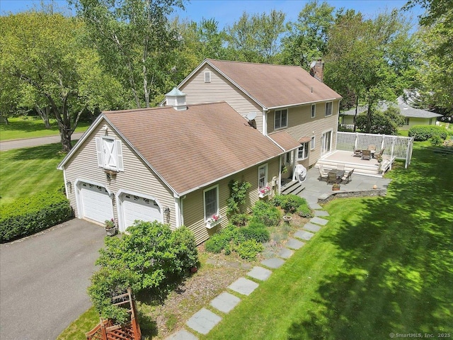 190 Bronson Dr, Middlebury, CT 06762 - view of front of home with a front lawn, a chimney, a garage, and a shingled roof