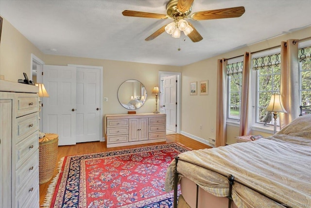 190 Bronson Dr, Middlebury, CT 06762 - bedroom featuring light wood-type flooring, a baseboard radiator, baseboards, and ceiling fan